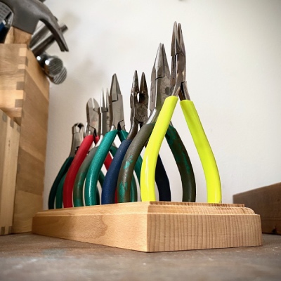 jewellery making pliers in a wooden stand inside an art studio